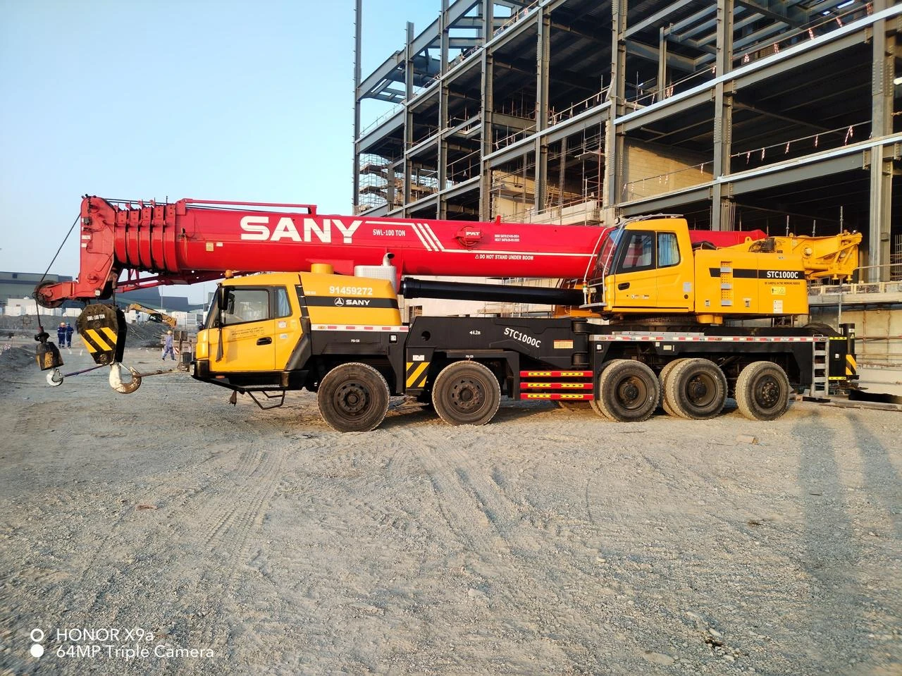 Mobile crane beside a steel structure